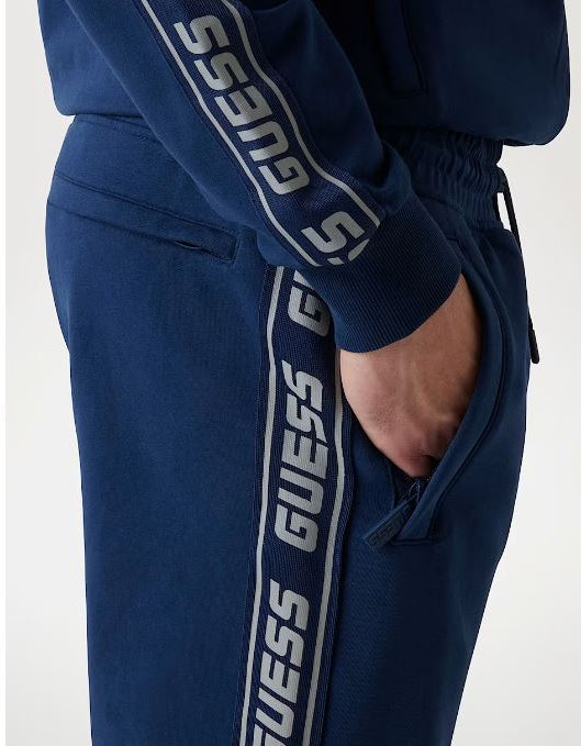 PANTALONI JOGGER GUESS BANDE LATERALI LOGO BLU